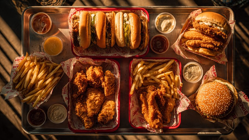Feature image showing multiple cookout chicken options in classic Cook Out trays.